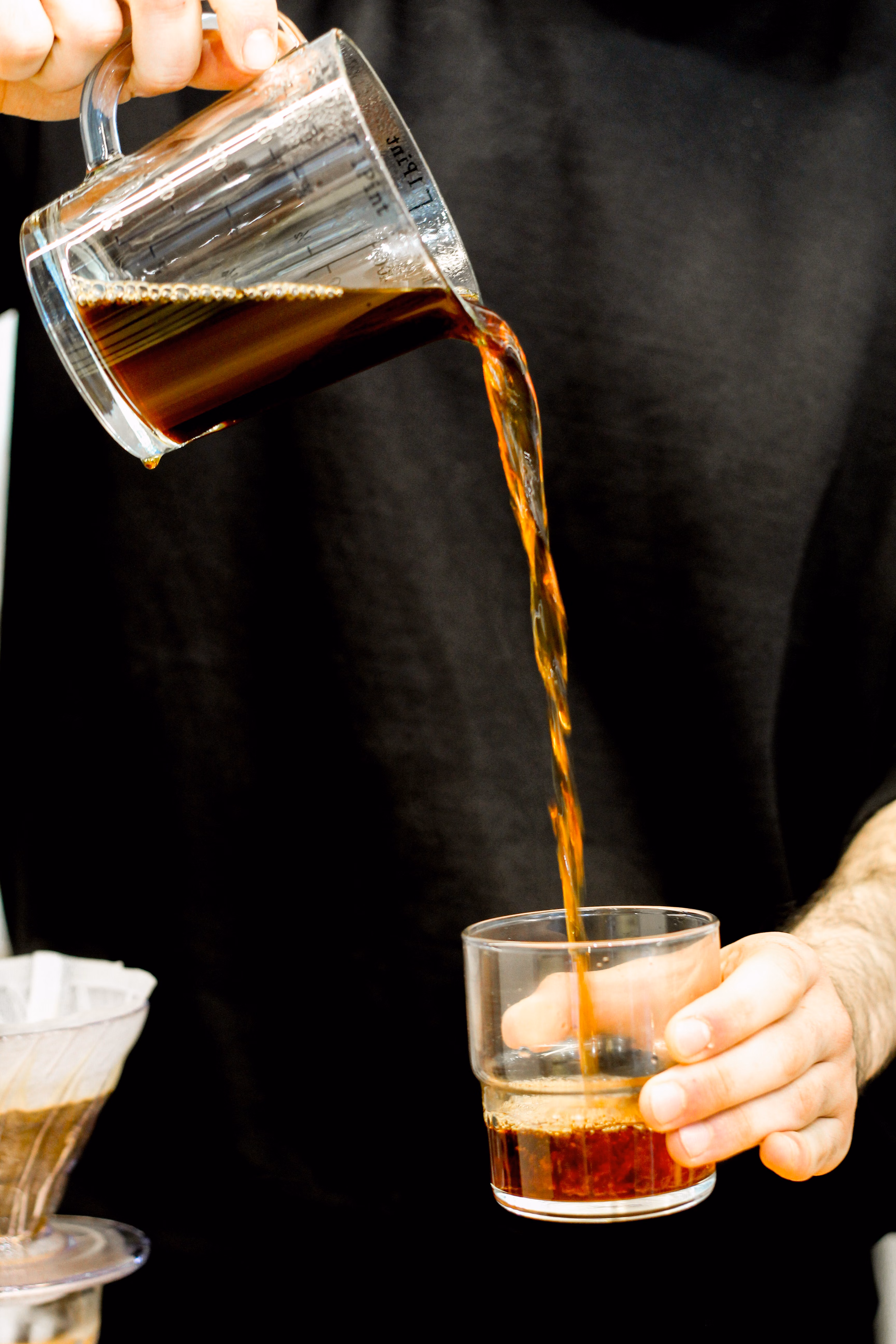 Pouring brewed coffee into a glass